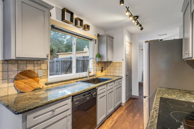 1737 Live Oak Ct, Lewisville, TX 75067 - kitchen with black appliances, wood finished floors, gray cabinets, tasteful backsplash, and dark stone counters