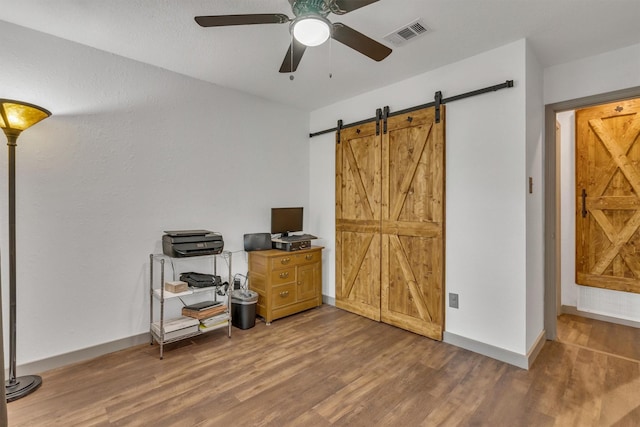 1737 Live Oak Ct, Lewisville, TX 75067 - bedroom featuring wood finished floors, a barn door, and ceiling fan