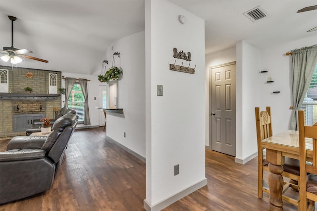 1737 Live Oak Ct, Lewisville, TX 75067 - living room with a ceiling fan, a brick fireplace, dark wood finished floors, and lofted ceiling