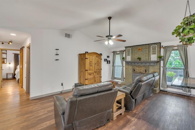 1737 Live Oak Ct, Lewisville, TX 75067 - living room with vaulted ceiling, wood finished floors, a brick fireplace, and a ceiling fan