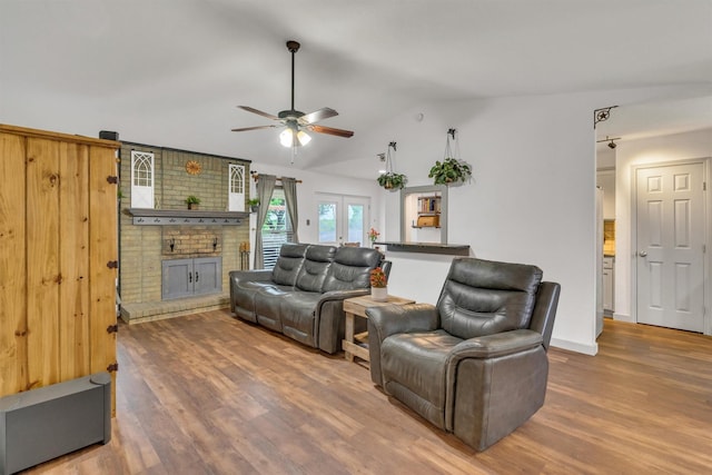 1737 Live Oak Ct, Lewisville, TX 75067 - living area with a brick fireplace, wood finished floors, a ceiling fan, lofted ceiling, and french doors