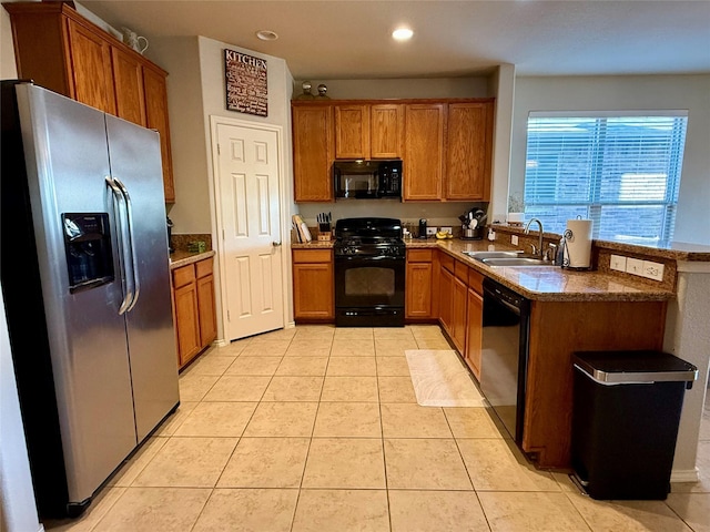 1117 Prairie Heights Dr, Fort Worth, TX 76108 - kitchen with black appliances, brown cabinetry, recessed lighting, light tile patterned floors, and a peninsula