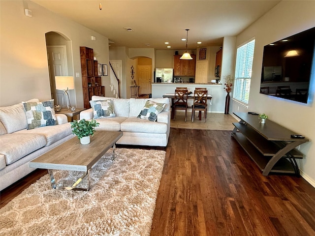 1117 Prairie Heights Dr, Fort Worth, TX 76108 - living room featuring arched walkways, dark wood-type flooring, and recessed lighting