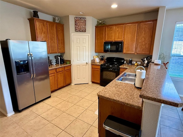 1117 Prairie Heights Dr, Fort Worth, TX 76108 - kitchen with black appliances, brown cabinetry, a peninsula, light tile patterned floors, and recessed lighting