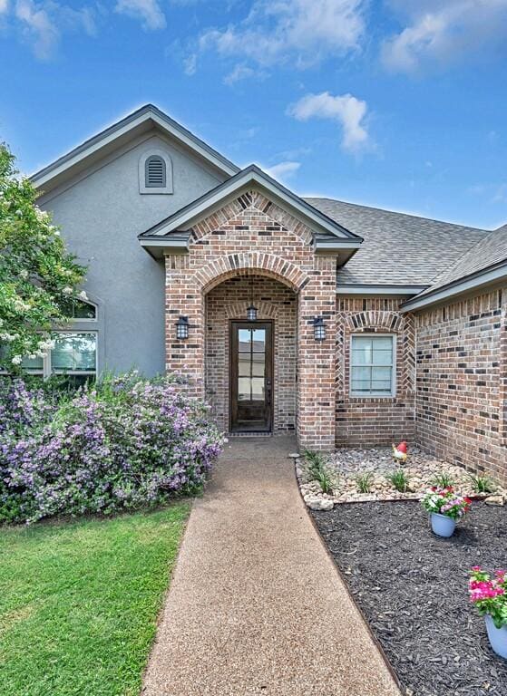 5432 Zavalla Dr, Waco, TX 76708 - property entrance featuring brick siding, stucco siding, and a shingled roof