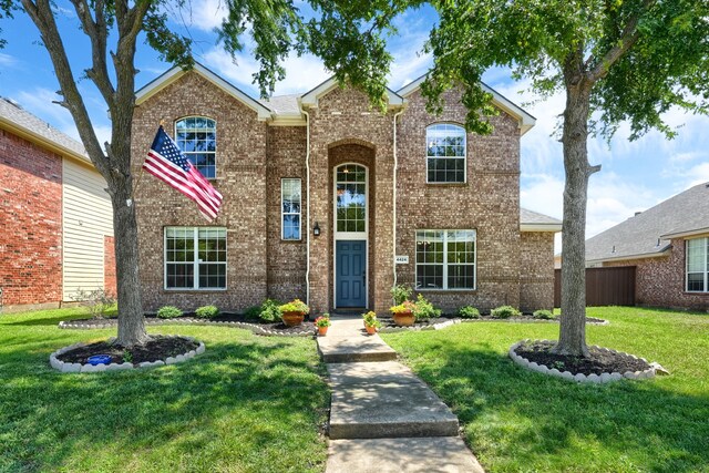4424 Ridge Point Ln, Plano, TX 75024 - traditional-style house with brick siding and a front lawn