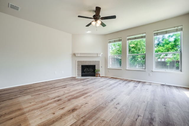 4424 Ridge Point Ln, Plano, TX 75024 - unfurnished living room featuring wood finished floors, ceiling fan, and a tiled fireplace