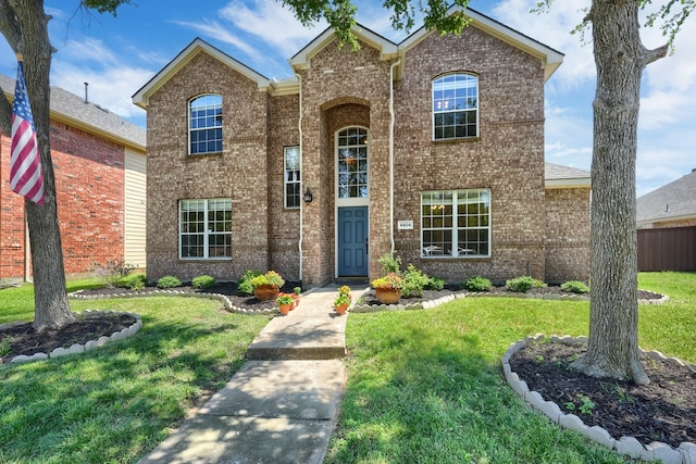 4424 Ridge Point Ln, Plano, TX 75024 - traditional-style house featuring a front lawn and brick siding