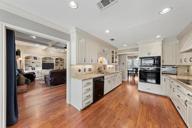 9600 Old Farm Rd, Woodway, TX 76712 - kitchen with black appliances, ornamental molding, recessed lighting, glass insert cabinets, and open floor plan