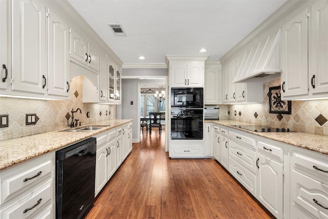9600 Old Farm Rd, Woodway, TX 76712 - kitchen featuring black appliances, white cabinetry, glass insert cabinets, light wood-style flooring, and light stone countertops
