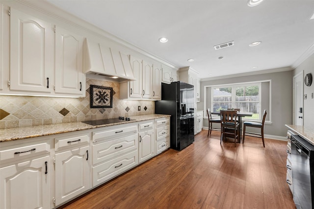 9600 Old Farm Rd, Woodway, TX 76712 - kitchen featuring black appliances, custom range hood, ornamental molding, hardwood / wood-style flooring, and white cabinets