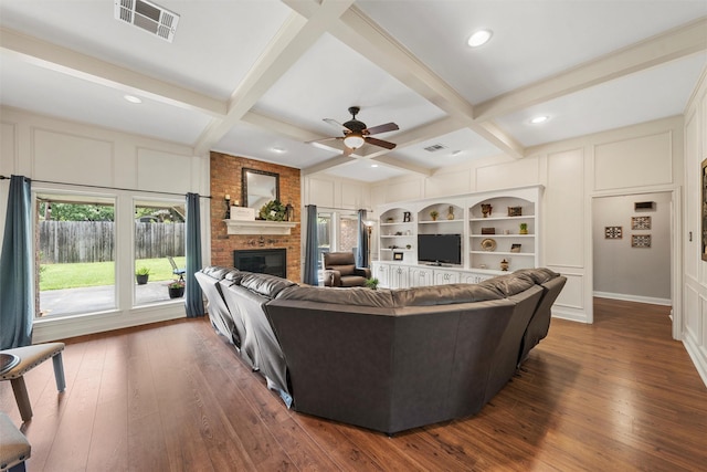 9600 Old Farm Rd, Woodway, TX 76712 - living area featuring a decorative wall, a brick fireplace, dark wood-style flooring, coffered ceiling, and beam ceiling