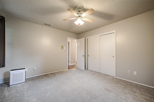 531 Himes Dr, Euless, TX 76039 - unfurnished bedroom with carpet, a textured ceiling, a closet, and ceiling fan