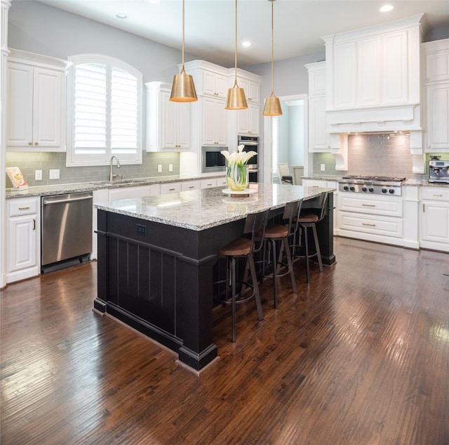 13896 Evergreen Dr, Frisco, TX 75035 - kitchen with stainless steel appliances, a kitchen island, recessed lighting, white cabinets, and tasteful backsplash