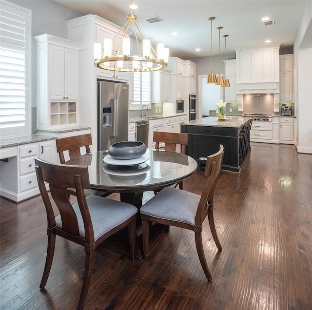 13896 Evergreen Dr, Frisco, TX 75035 - dining room with a chandelier, plenty of natural light, dark wood-style floors, and recessed lighting