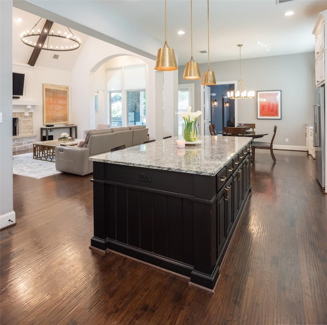 13896 Evergreen Dr, Frisco, TX 75035 - kitchen featuring a chandelier, dark cabinetry, arched walkways, recessed lighting, and dark wood finished floors