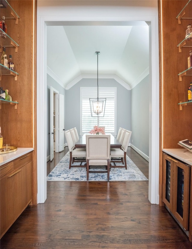 13896 Evergreen Dr, Frisco, TX 75035 - dining area with ornamental molding, lofted ceiling, dark wood-style floors, and a chandelier