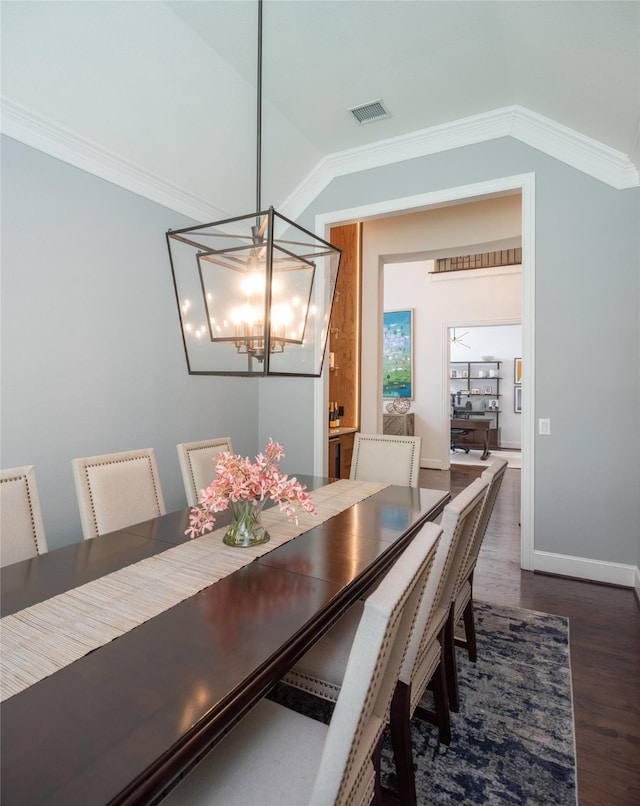 13896 Evergreen Dr, Frisco, TX 75035 - dining room with a chandelier, lofted ceiling, dark wood finished floors, and crown molding