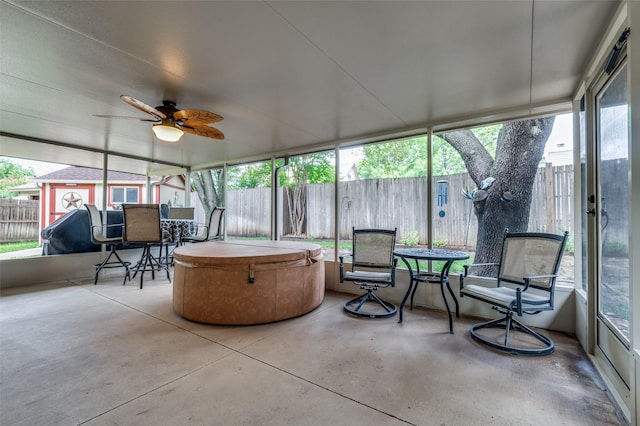 1405 Mapleton Ct, Arlington, TX 76018 - sunroom / solarium with a hot tub, finished concrete flooring, outdoor dining area, and ceiling fan