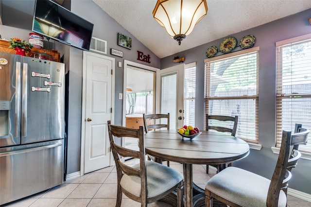 1405 Mapleton Ct, Arlington, TX 76018 - dining room with vaulted ceiling, a textured ceiling, and light tile patterned floors