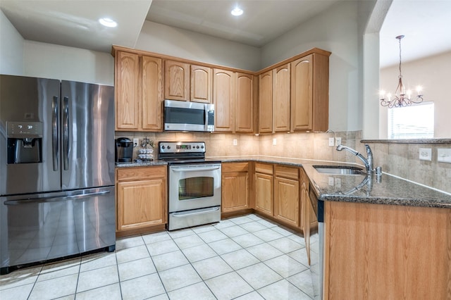 1138 Sophia St, Allen, TX 75013 - kitchen featuring stainless steel appliances, dark stone countertops, light tile patterned floors, backsplash, and recessed lighting