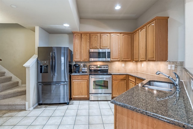 1138 Sophia St, Allen, TX 75013 - kitchen with stainless steel appliances, dark stone countertops, decorative backsplash, light tile patterned floors, and recessed lighting