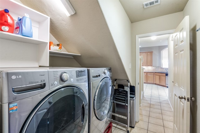 1138 Sophia St, Allen, TX 75013 - laundry area with washing machine and dryer and light tile patterned floors