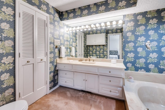 8220 Coolgreene Dr, Dallas, TX 75228 - bathroom with a closet, vanity, a garden tub, and wallpapered walls