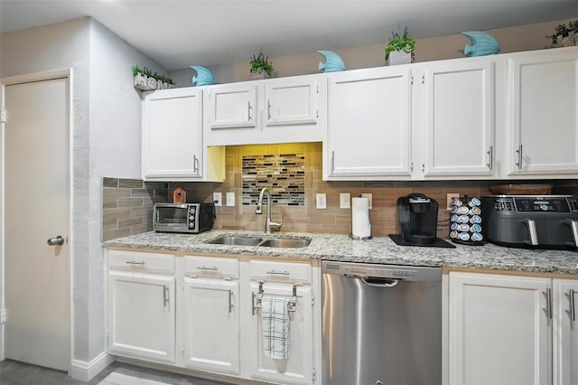 864 Warwick Dr, Plano, TX 75023 - kitchen featuring stainless steel dishwasher, backsplash, white cabinetry, and light stone countertops
