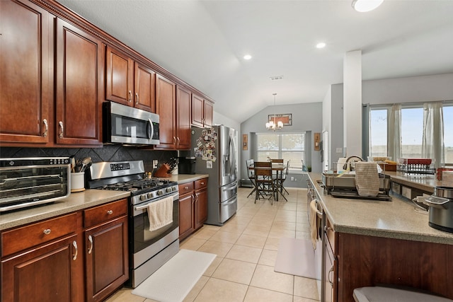 6436 Meadowcrest Ln, Sachse, TX 75048 - kitchen with stainless steel appliances, vaulted ceiling, a chandelier, tasteful backsplash, and light tile patterned floors