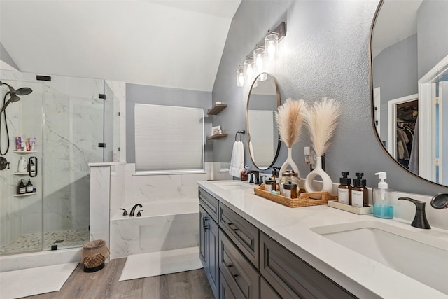 6436 Meadowcrest Ln, Sachse, TX 75048 - bathroom featuring a bath, a marble finish shower, lofted ceiling, double vanity, and wood finished floors
