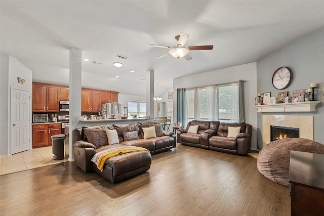 6436 Meadowcrest Ln, Sachse, TX 75048 - living room with ceiling fan, healthy amount of natural light, a tile fireplace, and light wood-style floors