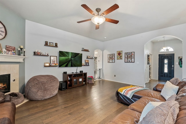 6436 Meadowcrest Ln, Sachse, TX 75048 - living area featuring arched walkways, hardwood / wood-style flooring, ceiling fan, and a fireplace