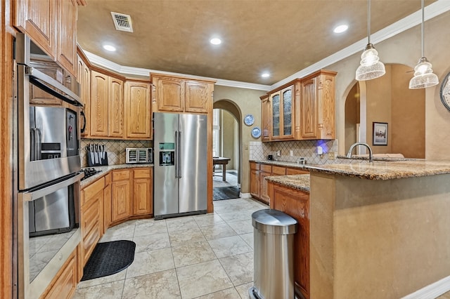 311 Timber Oaks Ct, Bowie, TX 76230 - kitchen featuring stainless steel appliances, arched walkways, light stone counters, tasteful backsplash, and glass insert cabinets
