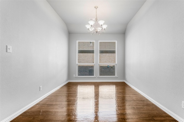 5608 Grove Cove Dr, Mckinney, TX 75071 - empty room featuring a chandelier, wood finished floors, and vaulted ceiling