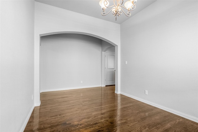 5608 Grove Cove Dr, Mckinney, TX 75071 - unfurnished room with arched walkways, a chandelier, wood finished floors, and vaulted ceiling