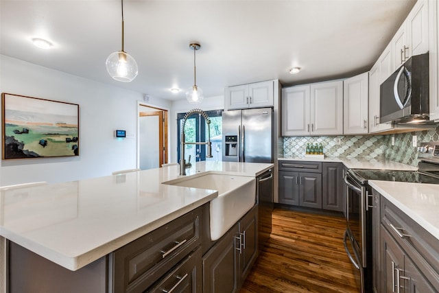 10649 Sylvia Dr, Dallas, TX 75228 - kitchen featuring appliances with stainless steel finishes, light countertops, dark wood-type flooring, tasteful backsplash, and white cabinets