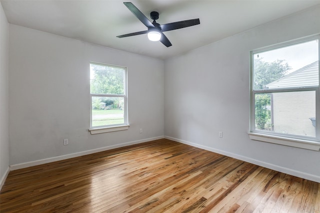 10649 Sylvia Dr, Dallas, TX 75228 - empty room with healthy amount of natural light, wood finished floors, and a ceiling fan