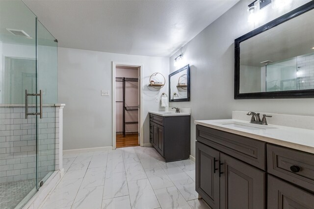 10649 Sylvia Dr, Dallas, TX 75228 - bathroom with a stall shower, two vanities, marble look tile flooring, and a walk in closet