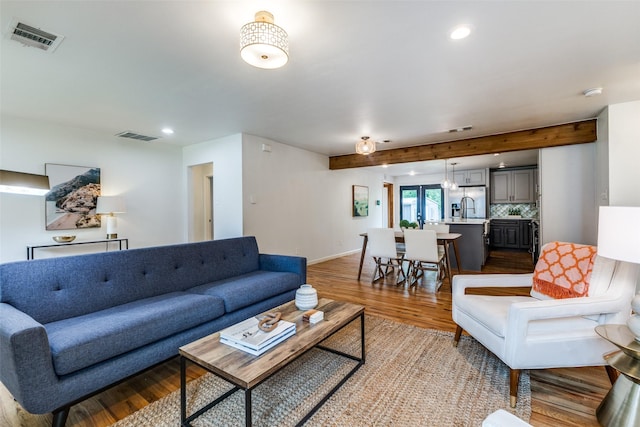 10649 Sylvia Dr, Dallas, TX 75228 - living room featuring light wood-type flooring, recessed lighting, and beamed ceiling