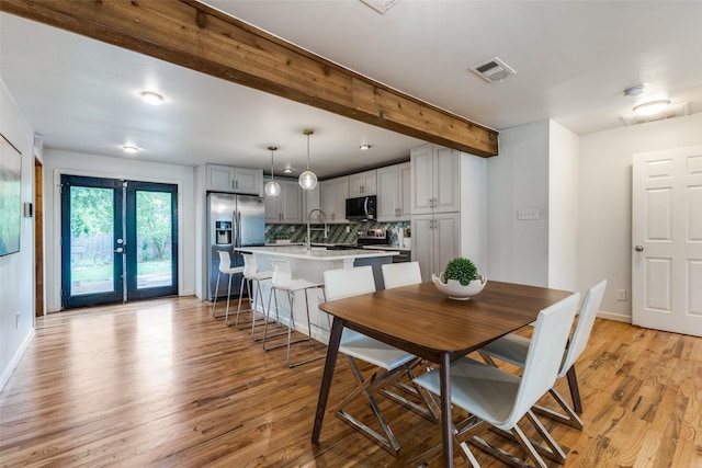 10649 Sylvia Dr, Dallas, TX 75228 - dining area featuring light wood-style flooring and beam ceiling