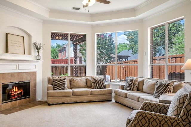 2484 Campfire Ln, Frisco, TX 75033 - carpeted living room with a ceiling fan, crown molding, a tray ceiling, and plenty of natural light