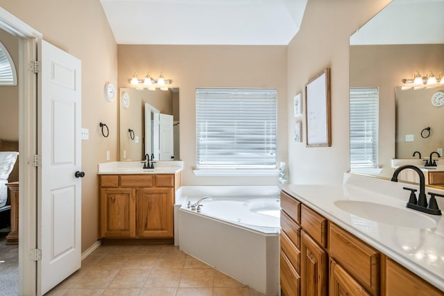 2484 Campfire Ln, Frisco, TX 75033 - full bathroom featuring two vanities, a jetted tub, and tile patterned floors