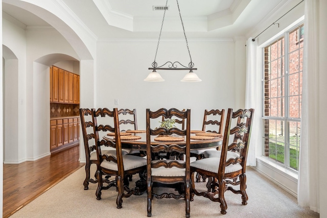 2484 Campfire Ln, Frisco, TX 75033 - dining area with crown molding, arched walkways, a tray ceiling, and wood finished floors
