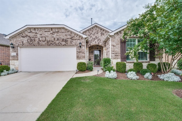 2129 Harbor Pointe Dr, Frisco, TX 75036 - french country home featuring concrete driveway, a front yard, a garage, brick siding, and stone siding