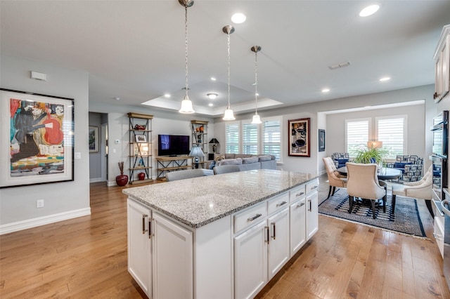 2129 Harbor Pointe Dr, Frisco, TX 75036 - kitchen with light wood finished floors, plenty of natural light, a center island, open floor plan, and recessed lighting