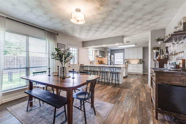 2521 Ridgecrest Dr, Garland, TX 75041 - dining area featuring dark wood finished floors and baseboards