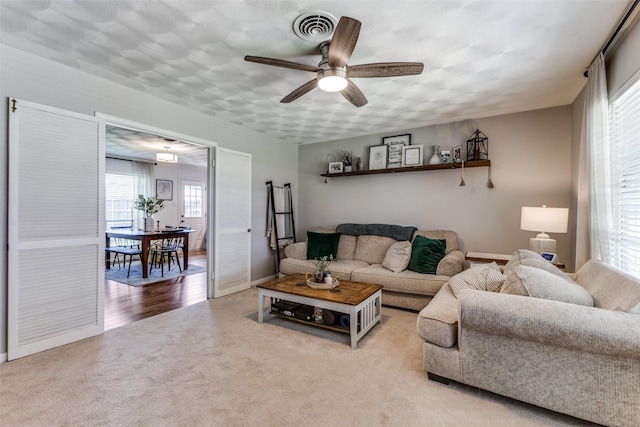 2521 Ridgecrest Dr, Garland, TX 75041 - carpeted living area featuring ceiling fan and baseboards