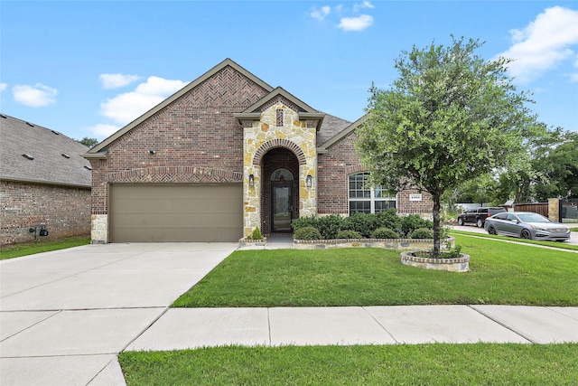 4300 Lakeview Dr, Frisco, TX 75036 - french provincial home featuring stone siding, a front yard, driveway, brick siding, and an attached garage
