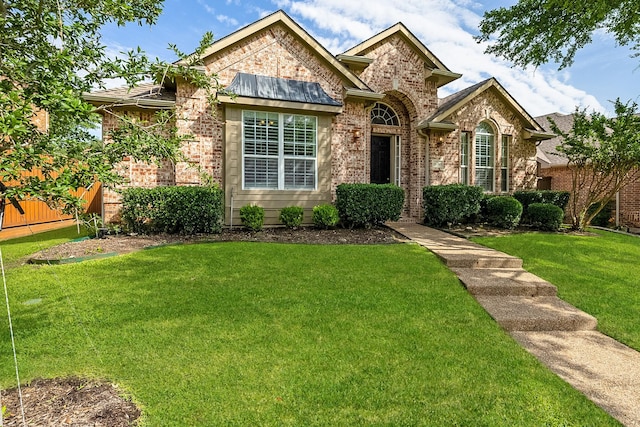 14760 Falling Leaf Dr, Frisco, TX 75035 - view of front of home featuring brick siding and a front yard